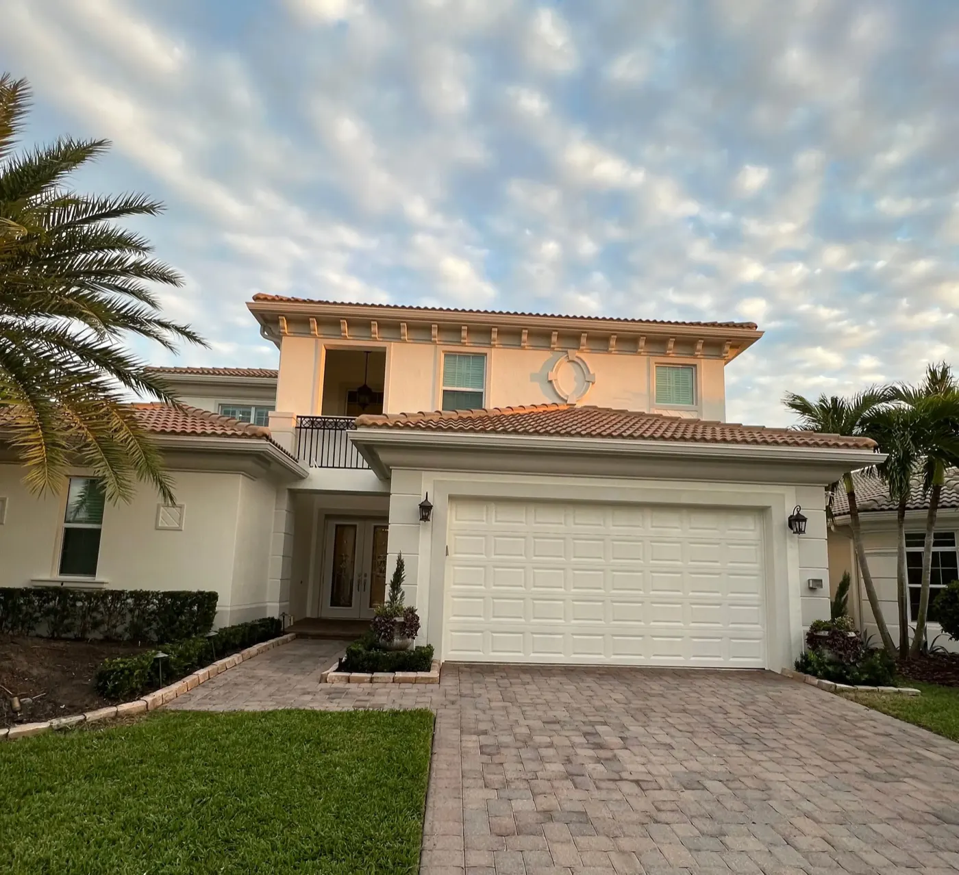Two-story home exterior repainted, photographed at dusk
