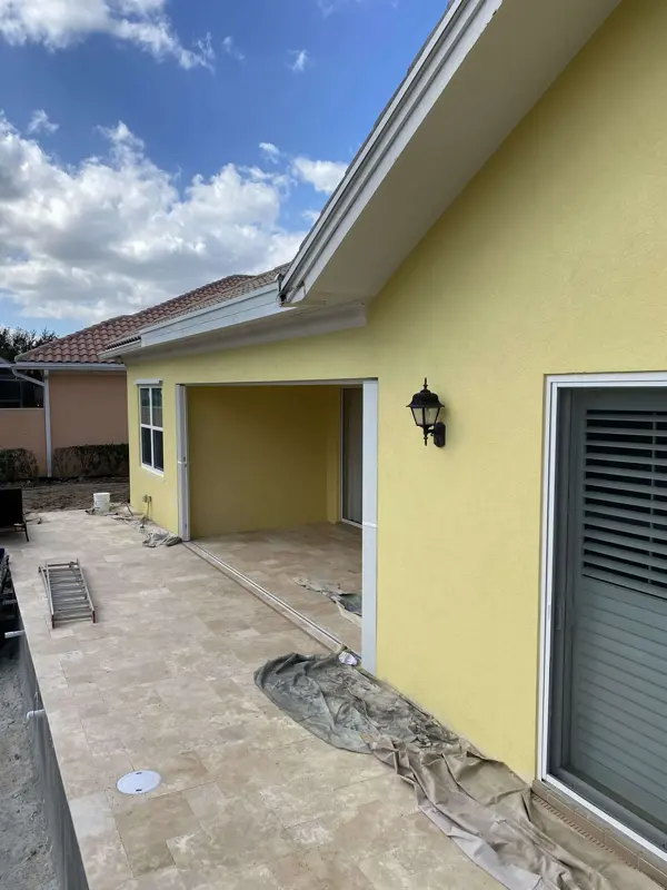 Exterior repaint in progress on a stucco home