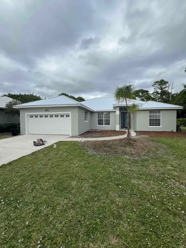Repainted home exterior with a new metal roof