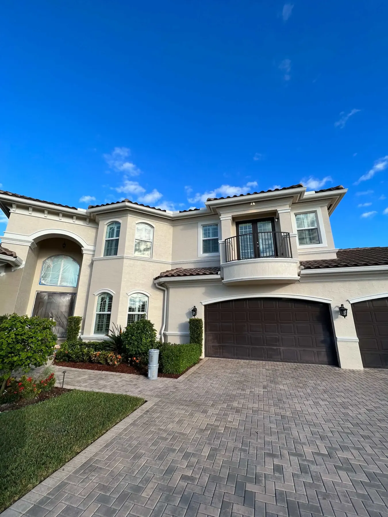 Two-story stucco home with a freshly painted exterior